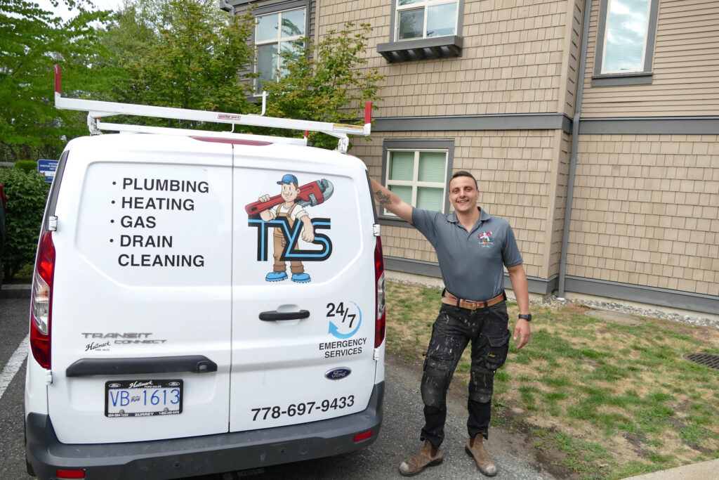 tyler from TYS Plumbing & Heating behind his work van